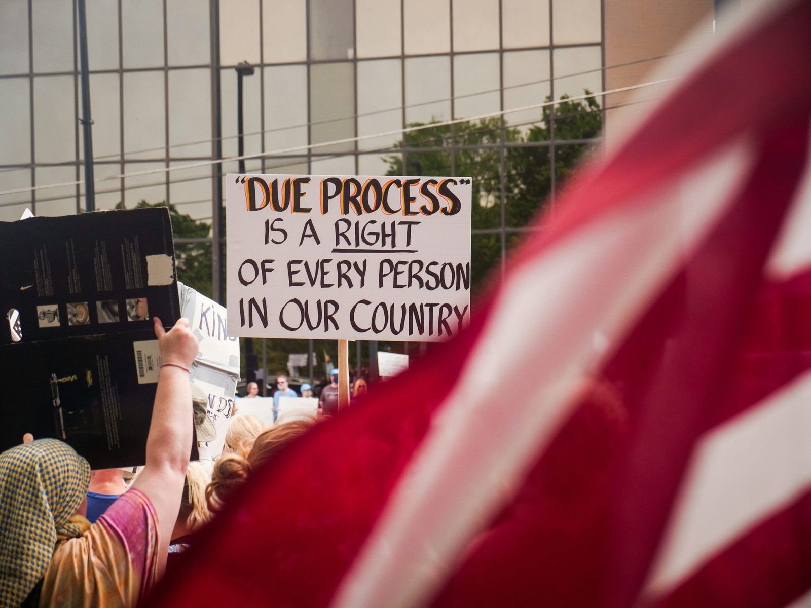Protesters holding a “Due Process Is a Right” sign during an immigration-related demonstration in the United States.